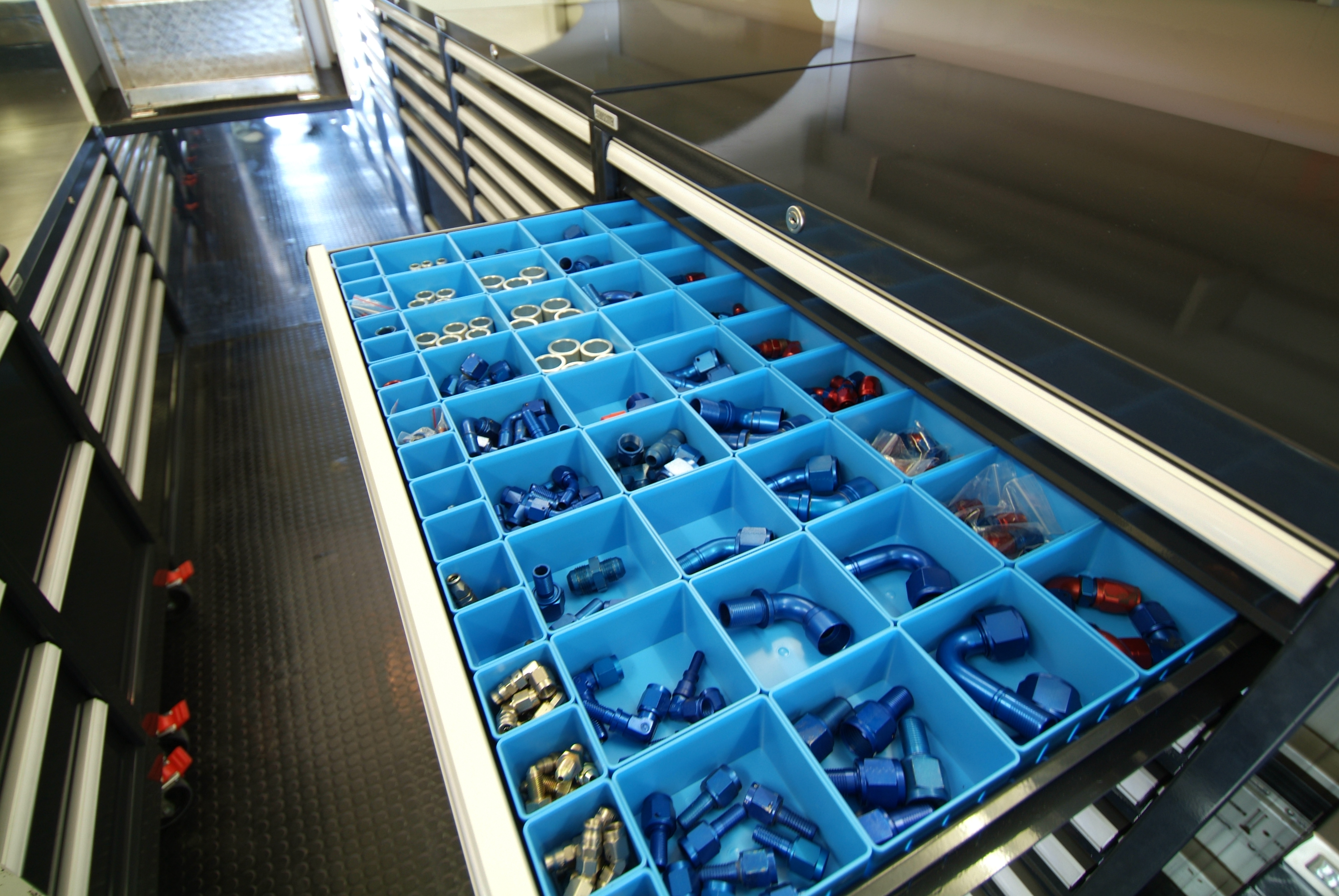 Boscotek high-density storage cabinet drawer filled with organised blue tool bins and assorted fittings.