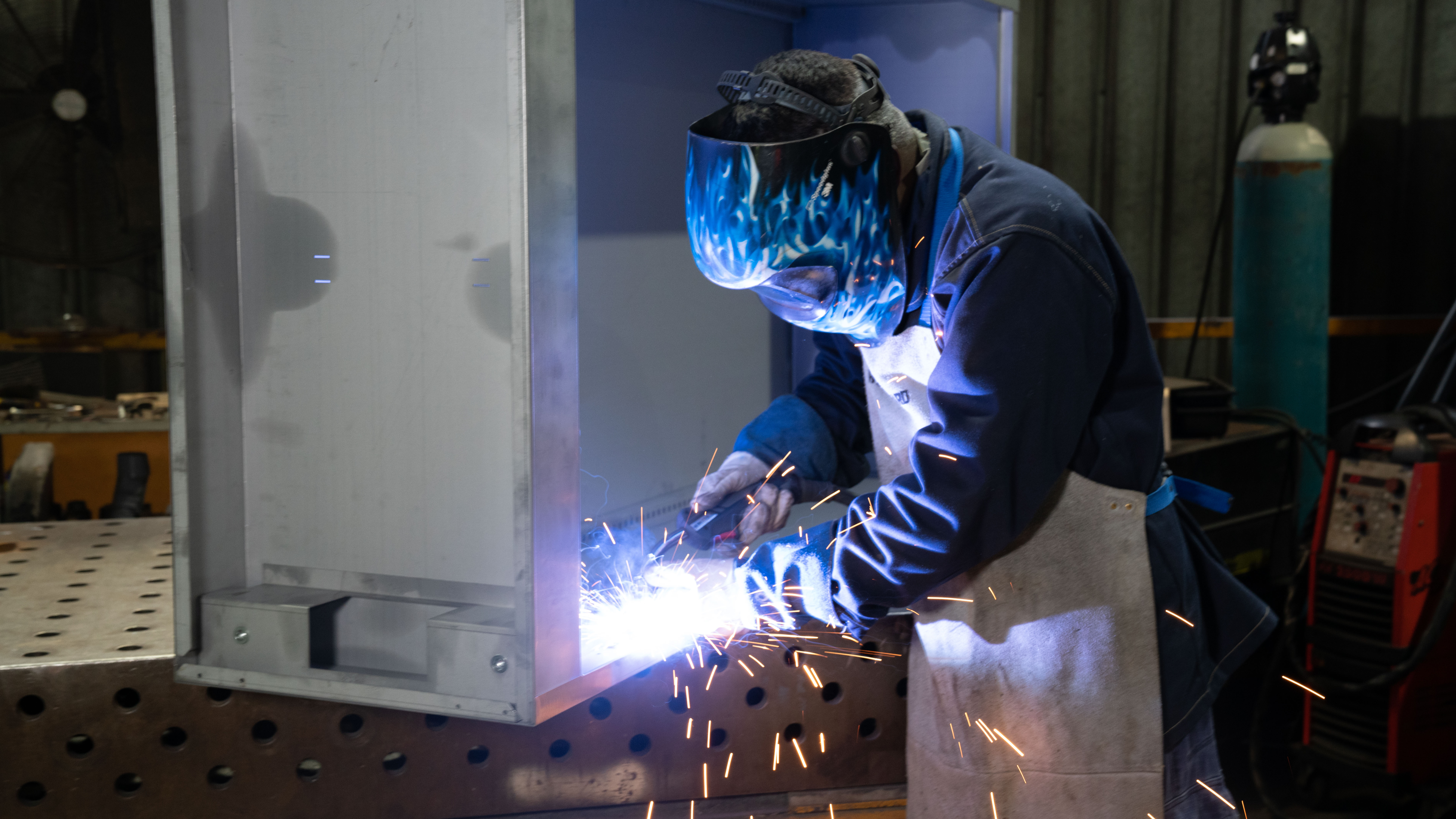 Wilson & Gilkes welder fabricating a custom metal enclosure in the workshop