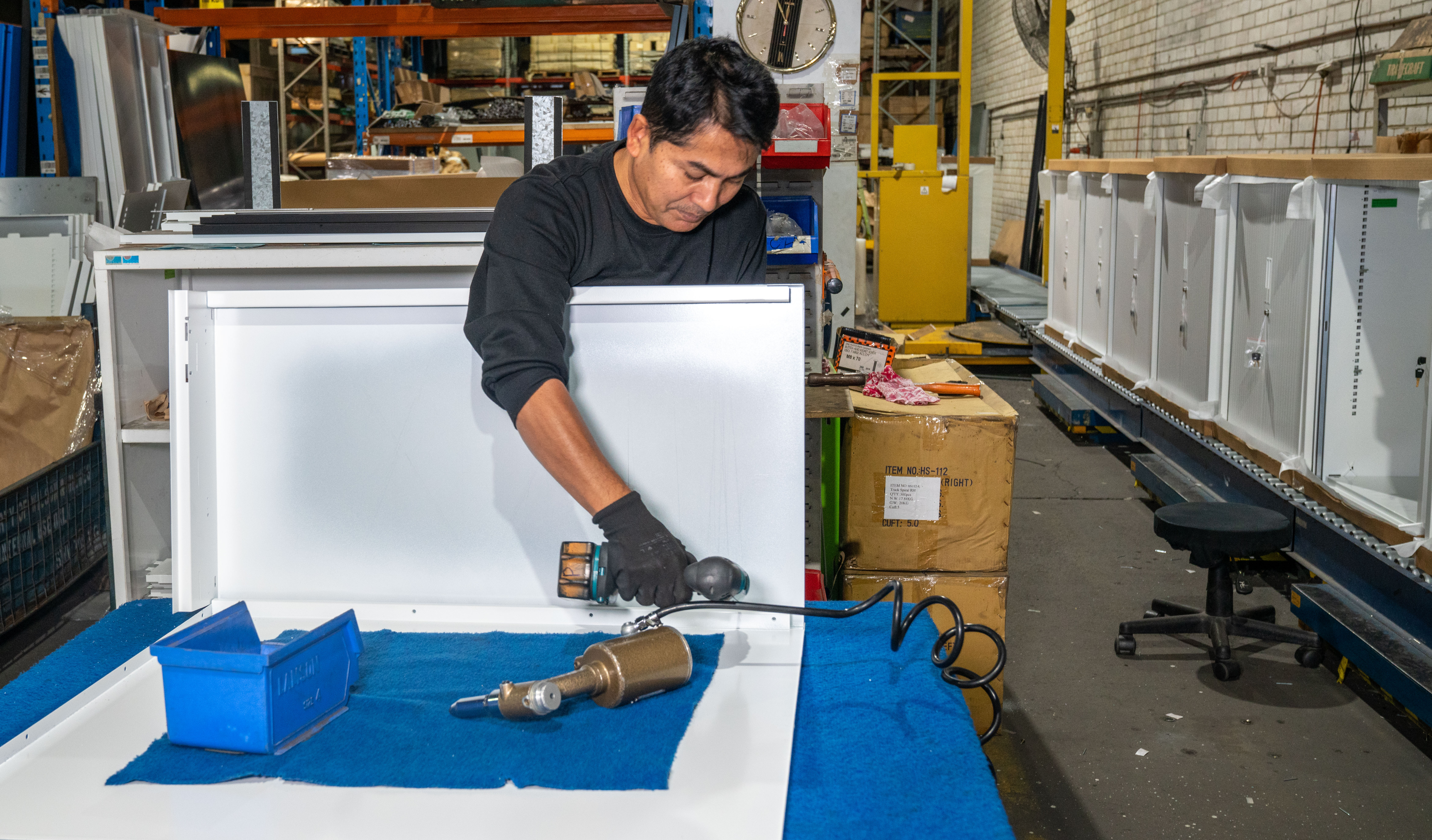 Wilson & Gilkes technician fabricating a custom metal enclosure in the workshop